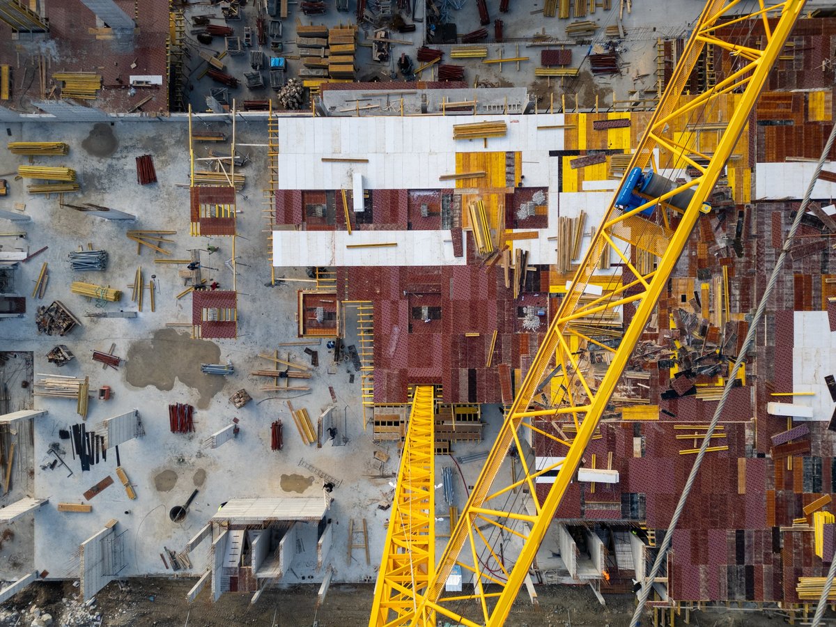 Aerial view of construction site with organized materials and workers