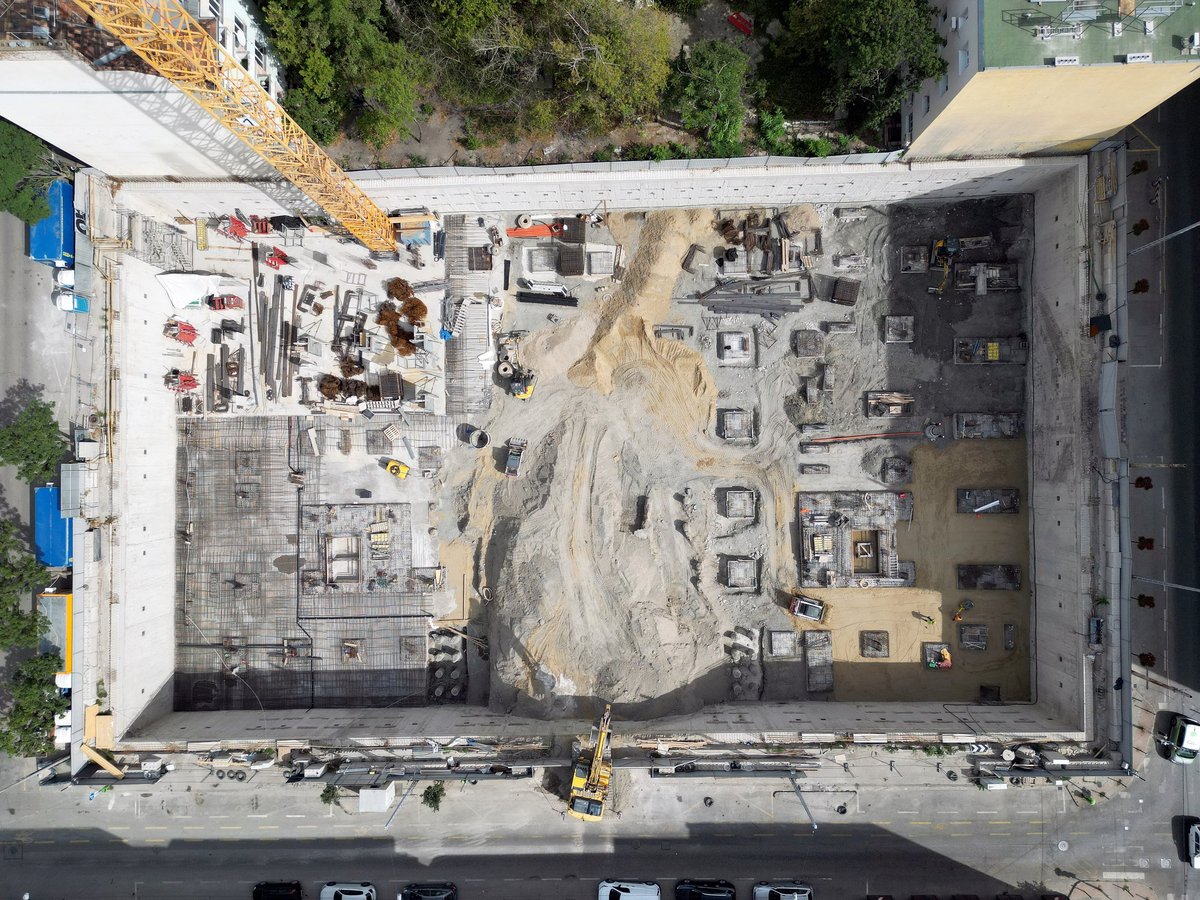 Aerial view of construction site with excavation and heavy machinery